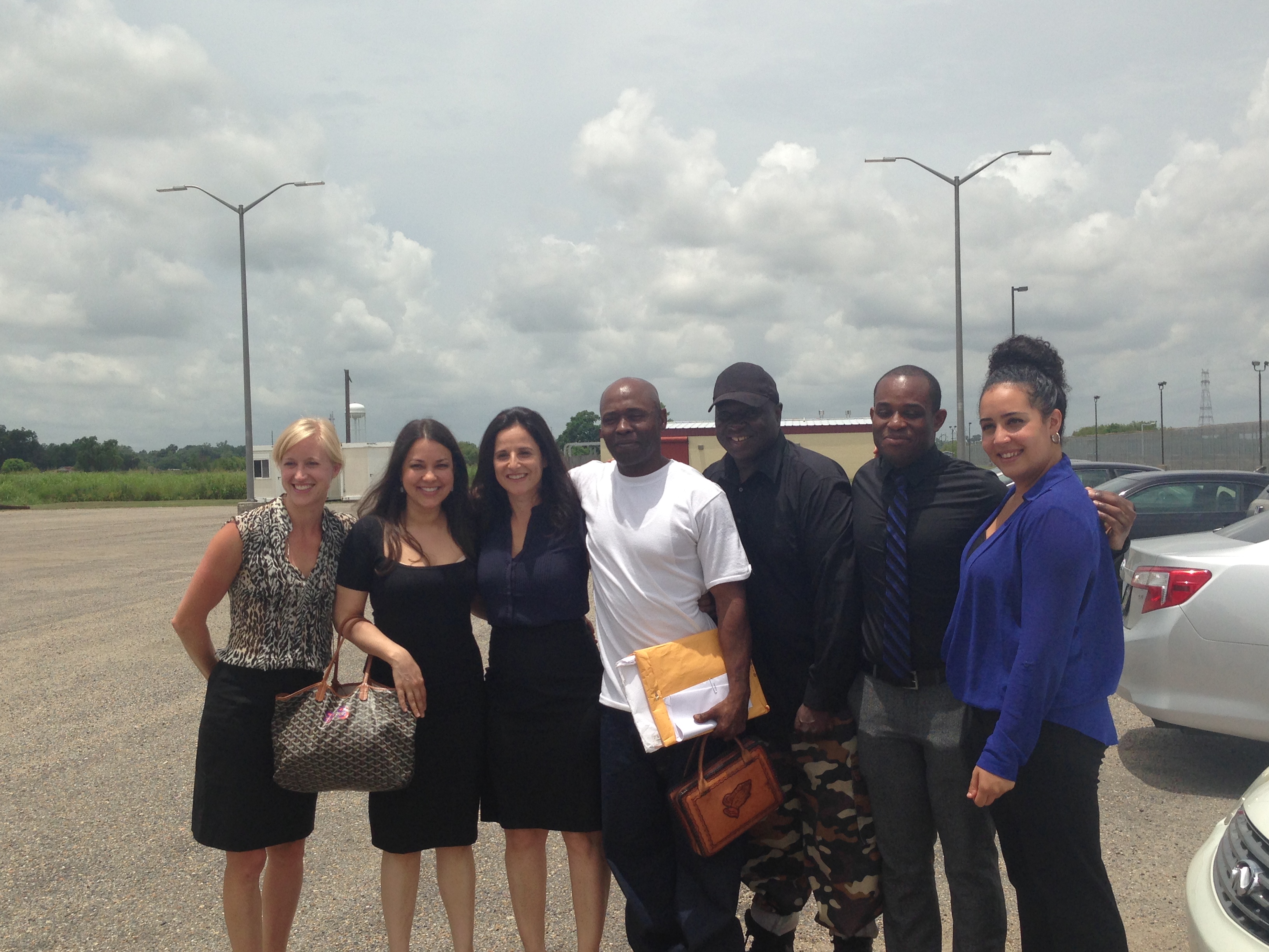 Nathan Brown smiling with attorneys and other members of his welcome party immediately after his release